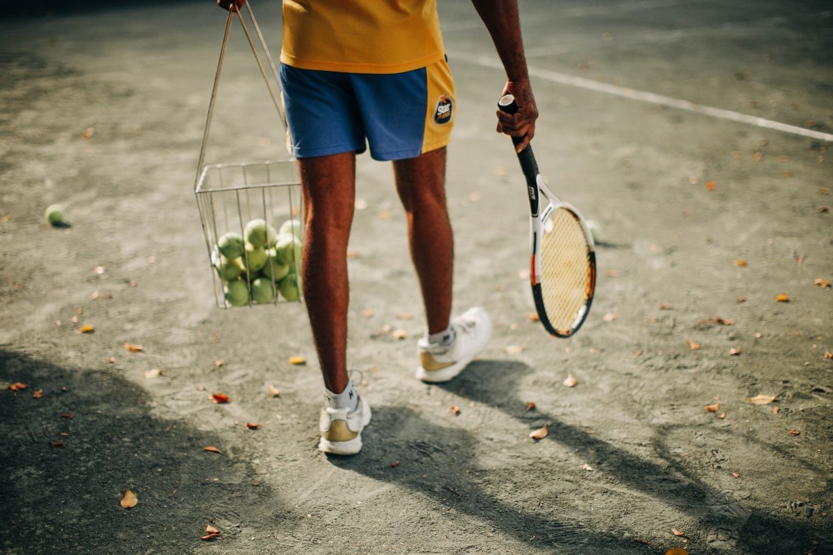 person-holding-tennis-racket-4371608_2